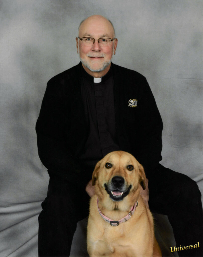 Monsignor Domin with his beloved Osso